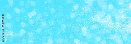 Bright blue sparkling glitter bokeh background, banner texture. Abstract defocused lights header. Wide screen wallpaper. Panoramic web banner with copy space for design