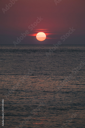 Fototapeta Naklejka Na Ścianę i Meble -  Sun fading in the horizon before sunset, Petani beach, Kefalonia