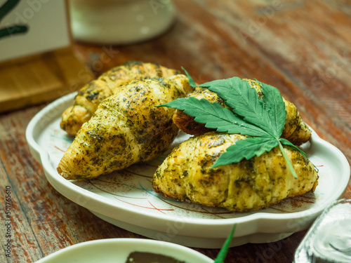 Obraz na plátně Croissants mix dried cannabis power and decorated with fresh lea