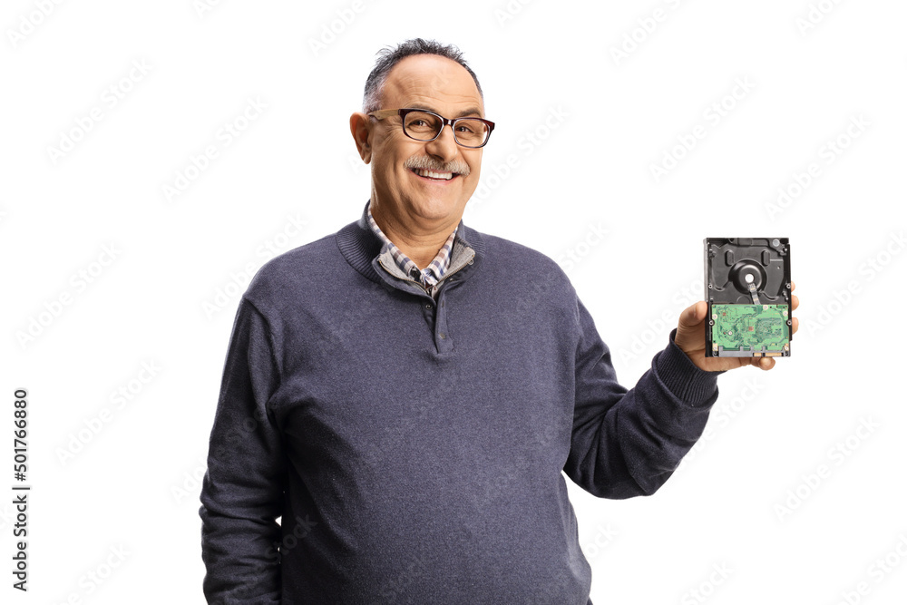 Smiling mature man holding a computer hard drive Smiling mature man holding a computer hard drive
