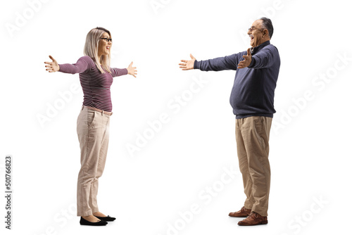 Full length profile shot of a young woman spreading arms to hug her father