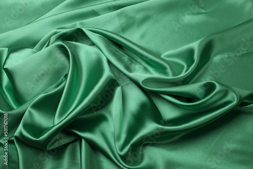 Green wave flow fabric silk. Abstract texture horizontal copy space background.