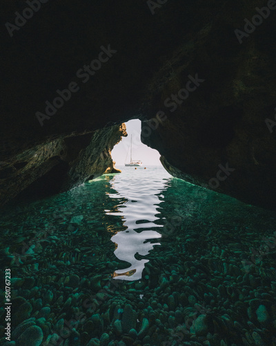 Sailing boat seen from a limestone cave at Kako Lagadi, Kefalonia photo