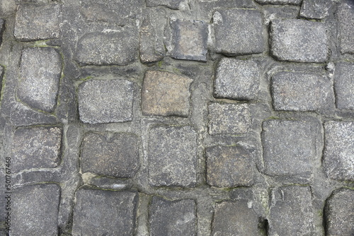 Close-up: Sandy cobblestones of a North Sea basalt groin joint with tarmac, use: background, texture (horizontal), Sahlenburg, Lower Saxony, Germany