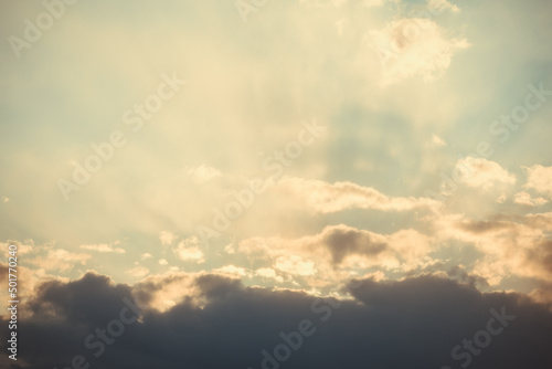 Dramatic sunset sky. The rays of the sun at sunset. Cloudy sky with sun rays. © colorshadow