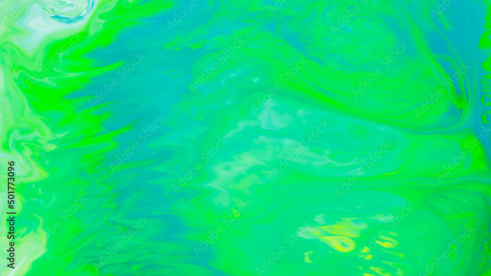 Fluid art background in green color. Green-turquoise stains on liquid. Creative background with blurred paints. Background for an eco-friendly concept