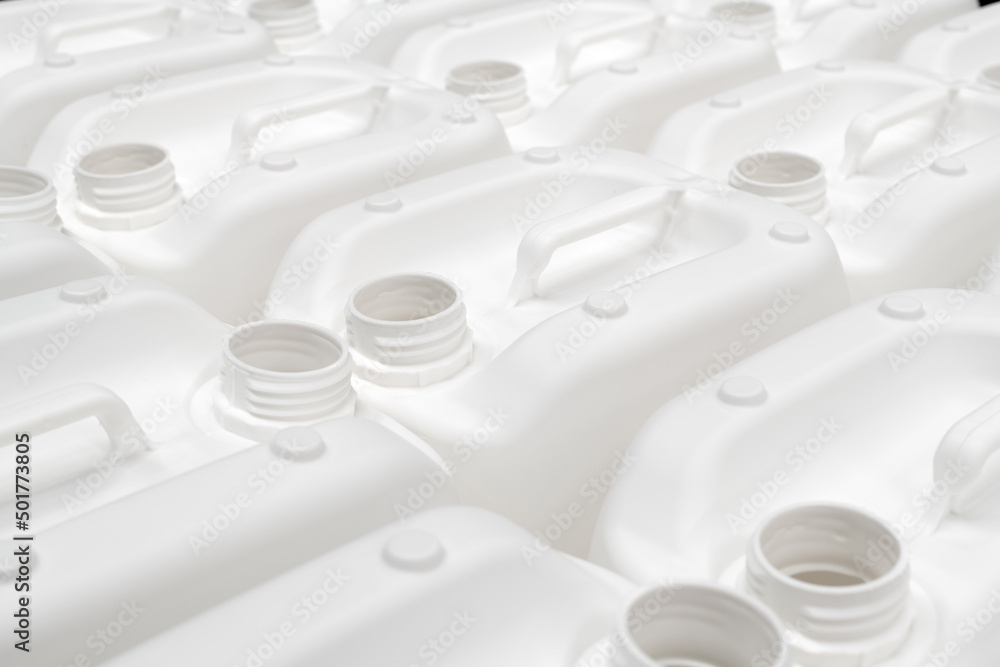 A group of white plastic jerry cans in a factory A group of white plastic jerry cans in a factory