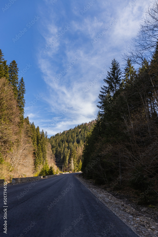 Fototapeta premium Empty road with mountains and blue sky at background.