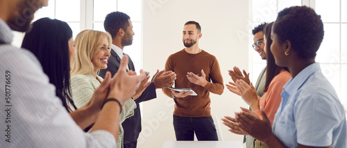 Tela Business team clapping hands after a speaker's presentation in a corporate meeting