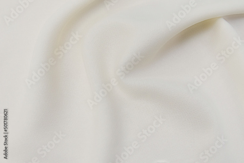 Close-up texture of natural beige or ivory fabric or cloth in brown color. Fabric texture of natural cotton or linen textile material. Beige canvas background.