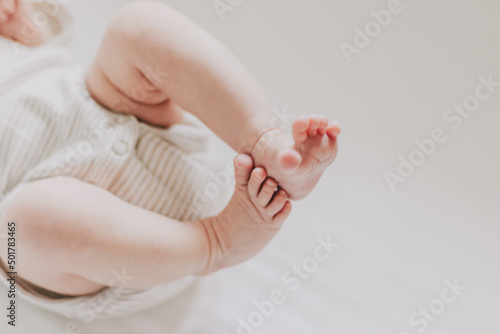 Close up of newborn feet. Soft focus. Beige palette.