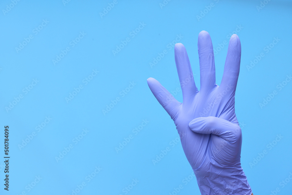 a hand in medical blue gloves shows a countdown of time or the number of drugs a hand in medical blue gloves shows a countdown of time or the number of drugs