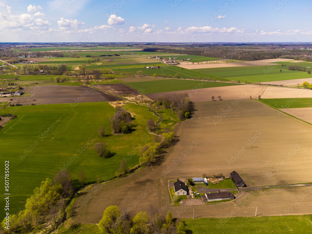Obraz premium Spring fields, meadows and villages seen from a bird's eye view on a sunny, clear day. Spring.