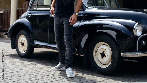 Black denim jeans on a model, close-up, a fashion advertising photo for a banner or catalog, new collection.