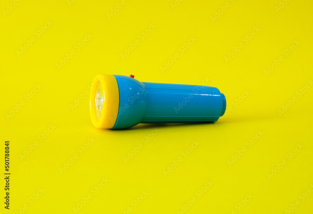 Flashlight on a bright yellow background. High quality photo. Flashlight on a bright yellow background. High quality photo.