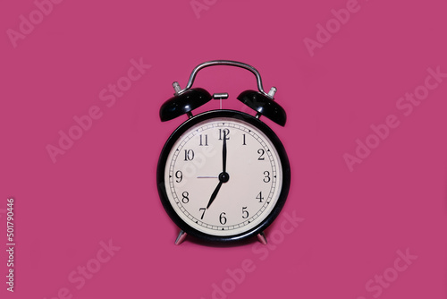 Clock alarm clock on a bright pink background