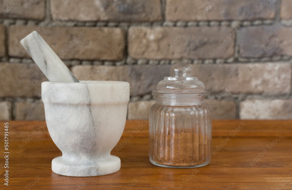 Natural Granite Pestle.Mortar Spice Herb. Spices in a jar in the kitchen. .Close-up. Selective focus Natural Granite Pestle.Mortar Spice Herb. Spices in a jar in the kitchen. .Close-up. Selective focus