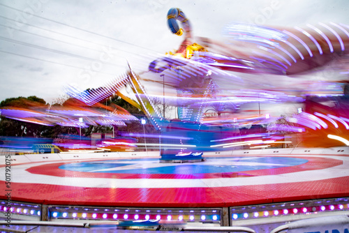 Hilarious fairground attractions, with lights of different colors blurred by movement
