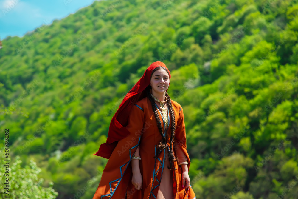 Georgian girl in national costume dances Georgian national dances. selective focus Georgian girl in national costume dances Georgian national dances. selective focus