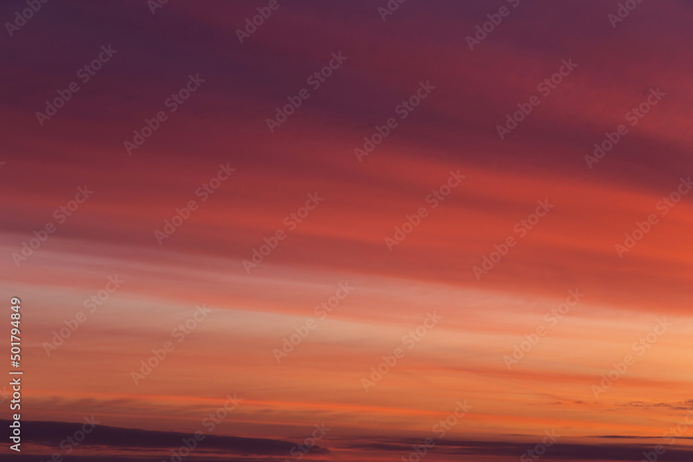 Beautiful soft sunrise, sunset yellow orange red striped sky with cirrus clouds abstract background texture