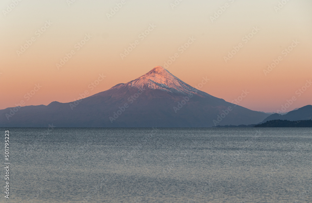View of a volcano and a lake at sunset 