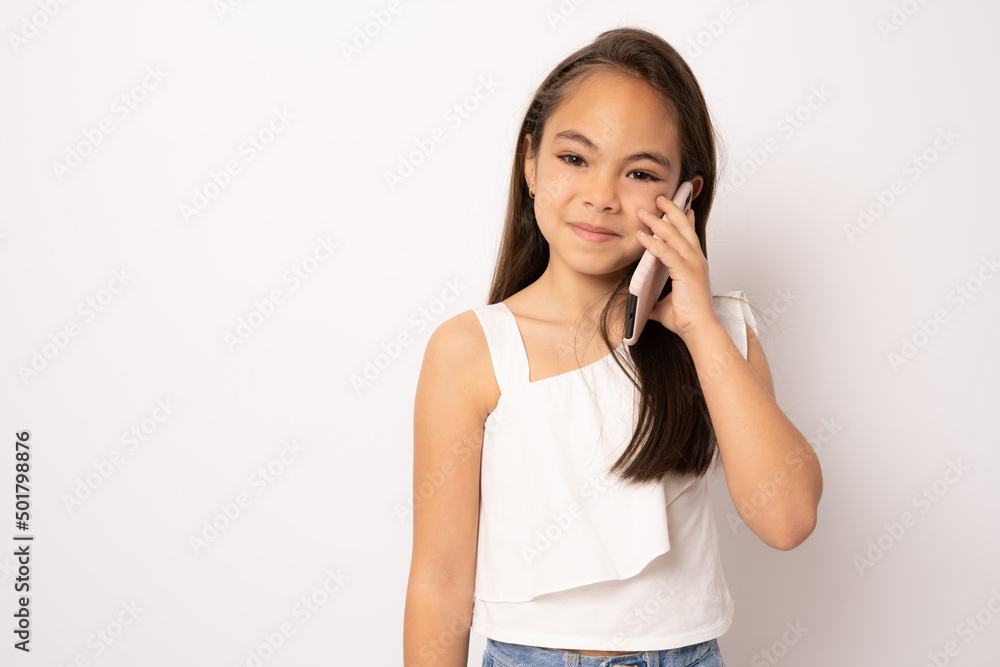 Cute beautiful little girl using smartphone on white background Cute beautiful little girl using smartphone on white background
