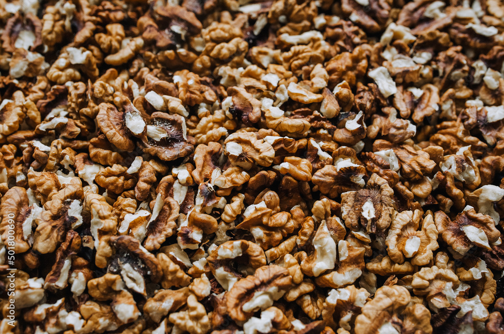 Background, texture of many brown walnuts, shelled nuts lying on the table. Food photography, top view, concept. Background, texture of many brown walnuts, shelled nuts lying on the table. Food photography, top view, concept.
