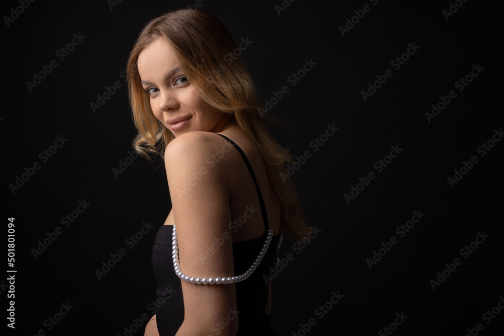 Fototapeta premium portrait on black background of young beautiful woman with makeup 