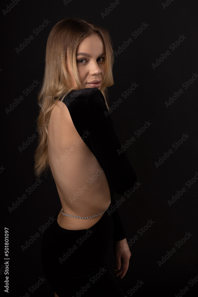 Naklejka premium sensual tender beautiful female in black dress with open back 
