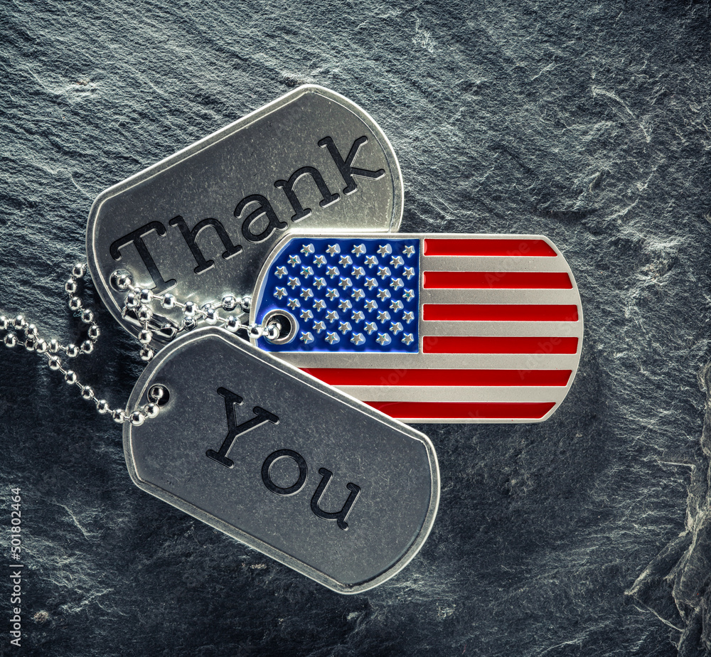 US military soldier's dog tags engraved with Thank You text and in the shape of the American flag. Memorial Day or Veterans Day concept. - obrazy, fototapety, plakaty 