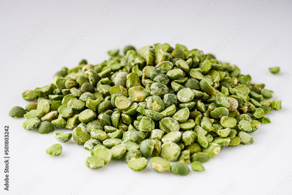 dried green peas on a white acrylic background dried green peas on a white acrylic background
