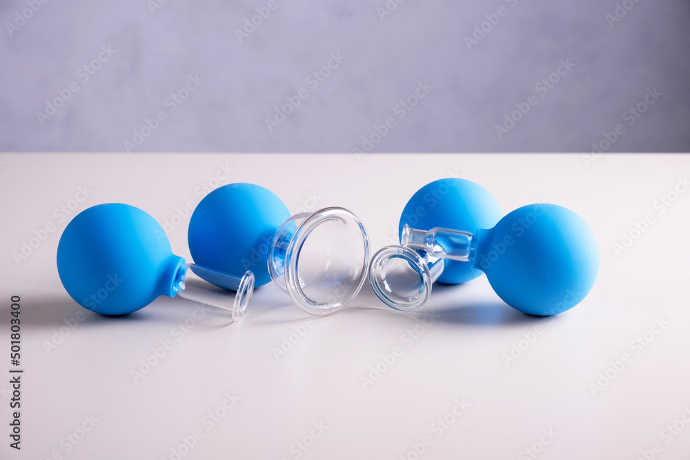 Vacuum pot for vacuum facial massage stands on a table. The concept of rejuvenation, face fitness and facial massage. Selective focus. Vacuum pot for vacuum facial massage stands on a table. The concept of rejuvenation, face fitness and facial massage. Selective focus.