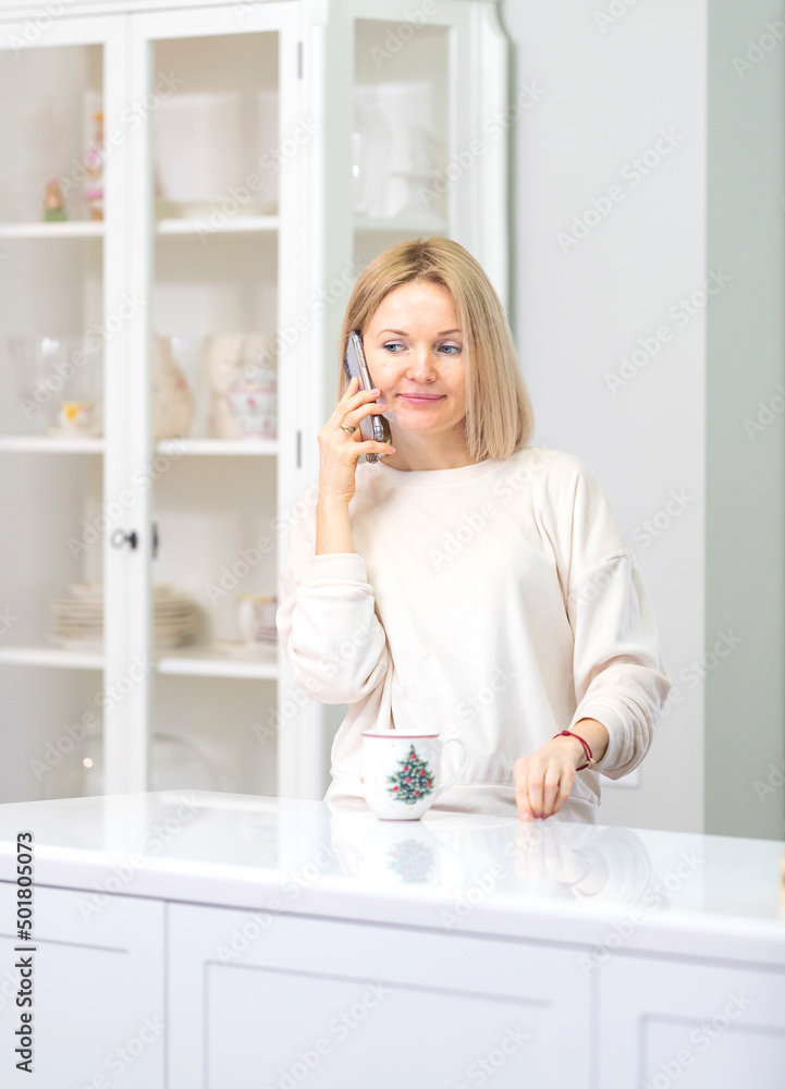 Young beautiful blonde girl at home in the kitchen Young beautiful blonde girl at home in the kitchen