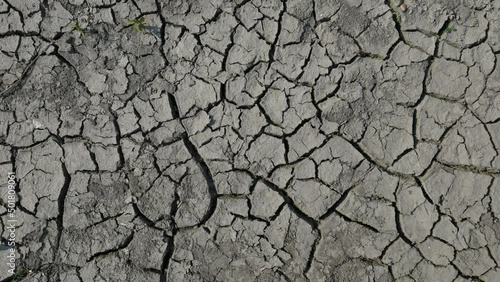 Lifeless desert land dry lake bed with cracked ground. Drought and crisis environment. Global warming. Lifeless, waterless soil due lack of moisture. Mud crack as result of reduction in water content