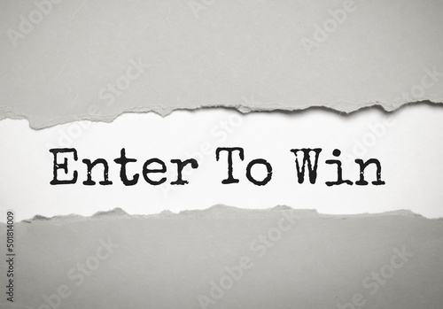 Enter to win text on paper. Word Enter to win on torn paper. Concept Image