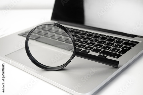 magnifying lens on the laptop keyboard in blue light
