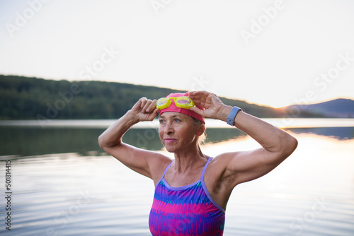 Fotografía Portrait of active senior woman swimmer outdoors by lake.