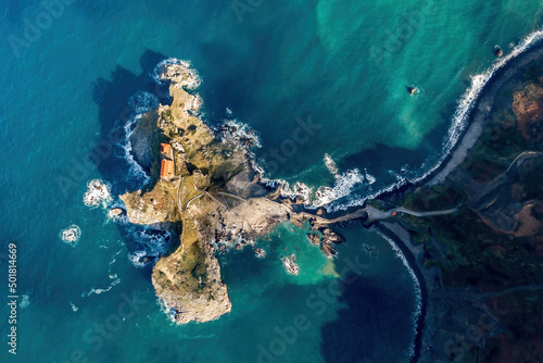 Aerial drone view of the island and the Gaztelugatxe temple. Northern Spain in winter. Manmade way to small isle on the Atlantic shore in Biscay region