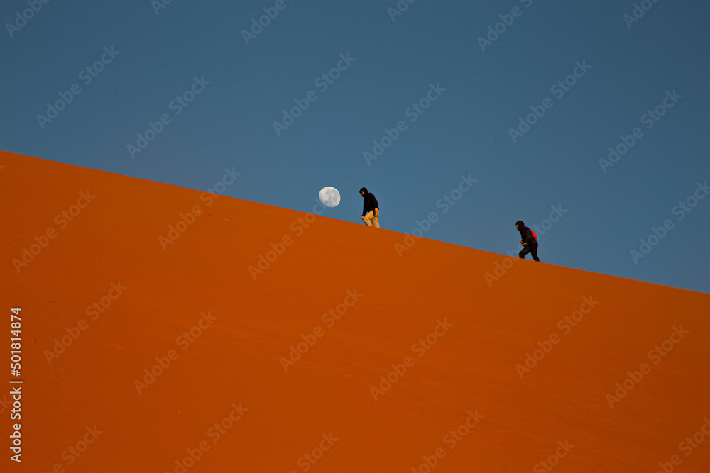 People walk on the dune in the Kalahari Desert, Namibia.