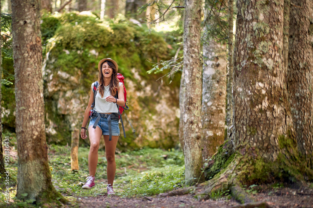 Girl trekking with backpacks walking in the forest . Girl trekking with backpacks walking in the forest .