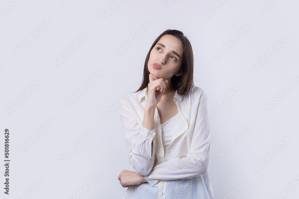Portrait of a beautiful young woman thinking, isolated on white background Portrait of a beautiful young woman thinking, isolated on white background