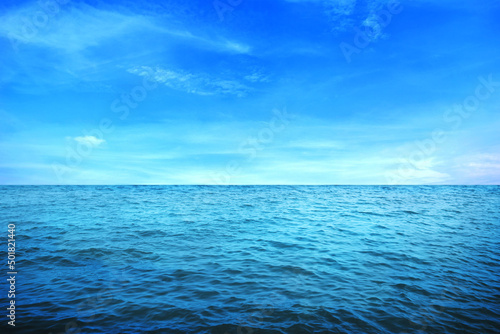 BLUE UNDER WATER waves and bubbles. Beautiful white clouds on blue sky over calm sea with sunlight reflection  Tranquil sea harmony of calm water surface. Sunny sky and calm blue ocean.