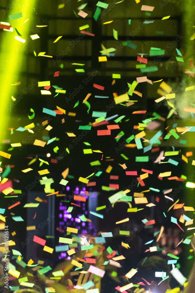 Thousands of confetti shot on air during a night festival. Ideal image for backgrounds. Multicolor are the confetti in the photo. The sky as a background is black. Thousands of confetti shot on air during a night festival. Ideal image for backgrounds. Multicolor are the confetti in the photo. The sky as a background is black.