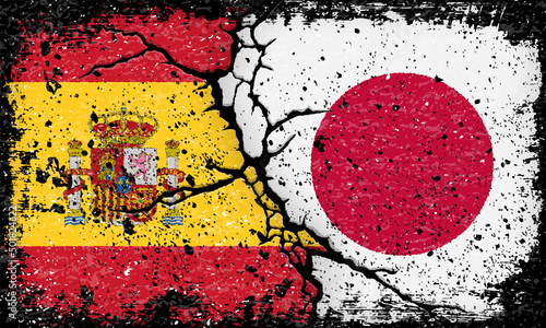 スペインと日本国旗が割れたコンクリートにペイントされたグランジ背景