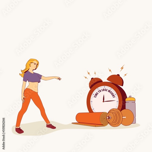 Sport young woman wearing casual workout clothes. Training and home exercising and fitness equipment. Dumbbell, yoga mat and bottle. Girl pointing at the alarm clock with time to lose weight text