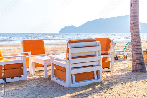 Sofa bench or seat and sofa on the sand beach of sea.