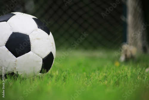 The child goes in for sports at the stadium. The boy is training before playing football.