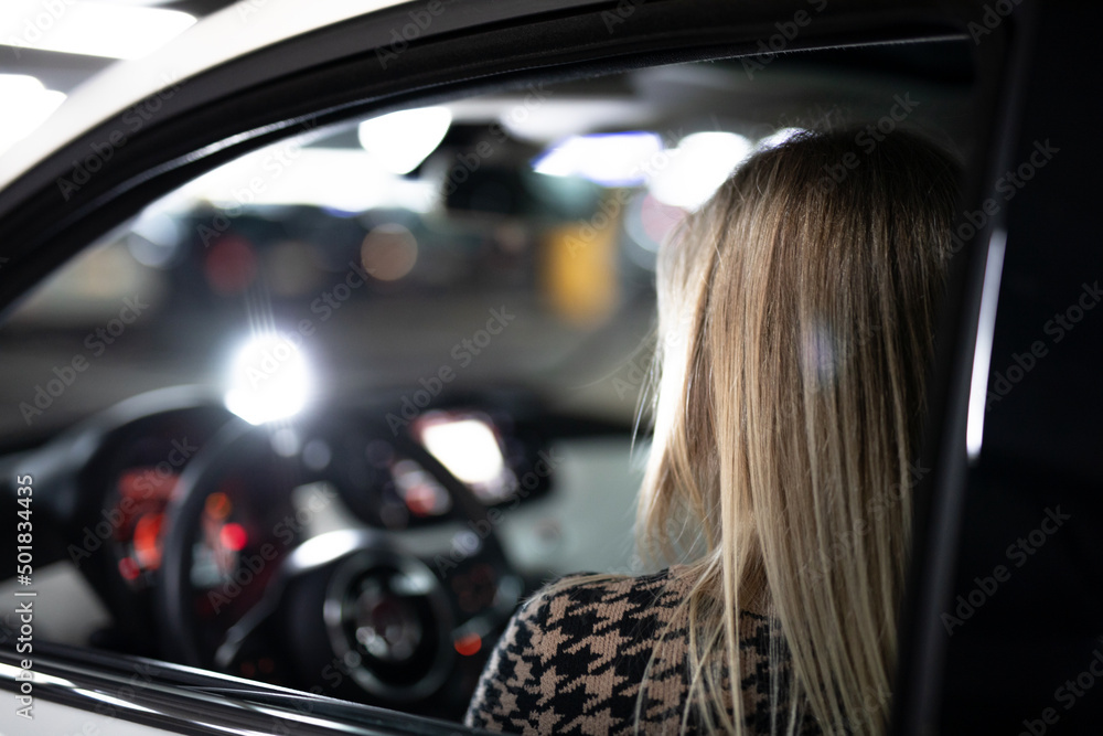 Frau bei Sonnenuntergang in der Stadt mit Auto bei Wind Frau bei Sonnenuntergang in der Stadt mit Auto bei Wind