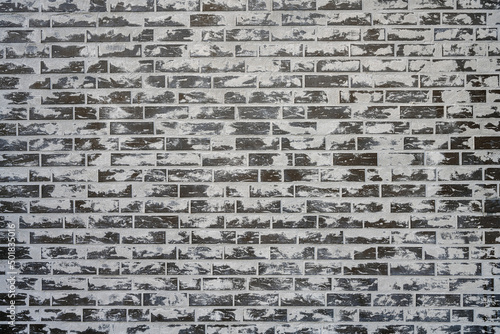 Background from a grey brick wall with a lot of cement on the surface