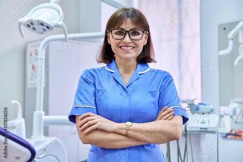 Portrait of smiling nurse looking at camera in dentistry. photo